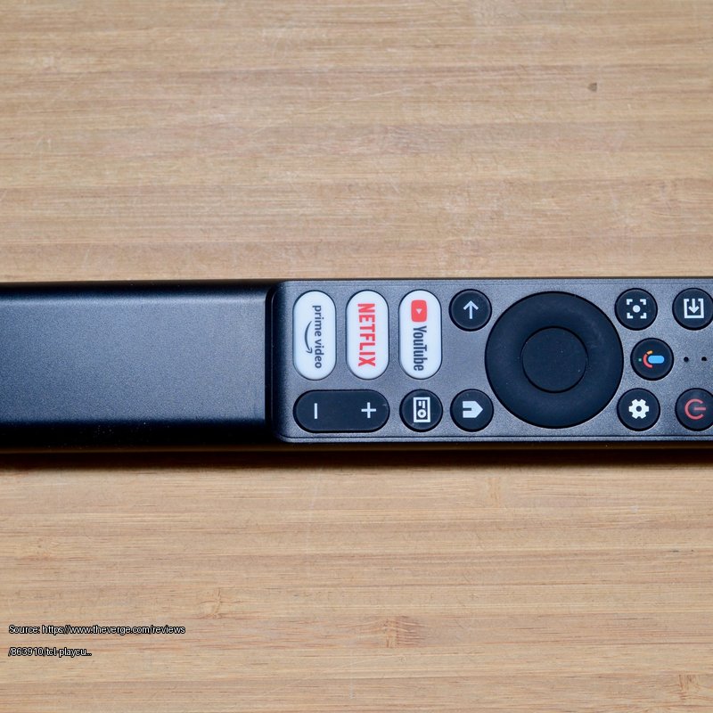 <em>The slim remote offers quick access buttons to popular services.</em> - Fair use review image from https://www.theverge.com/reviews/863910/tcl-playcube-portable-projector-review-battery